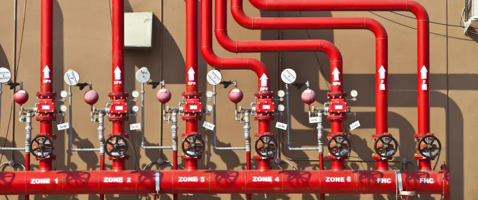 Complex network of red plumbing pipes