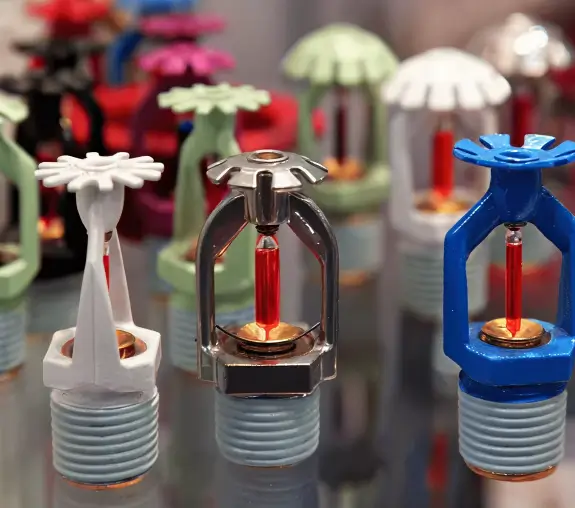 Assorted fire sprinkler mechanisms on table